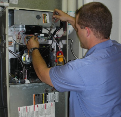 A Colony technician performing a diagnostic test on a furnace in Frisco