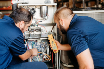 Two Colony technicians inspecting a piece of equipment in Frisco